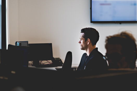 Man monitoring a system at his desk 