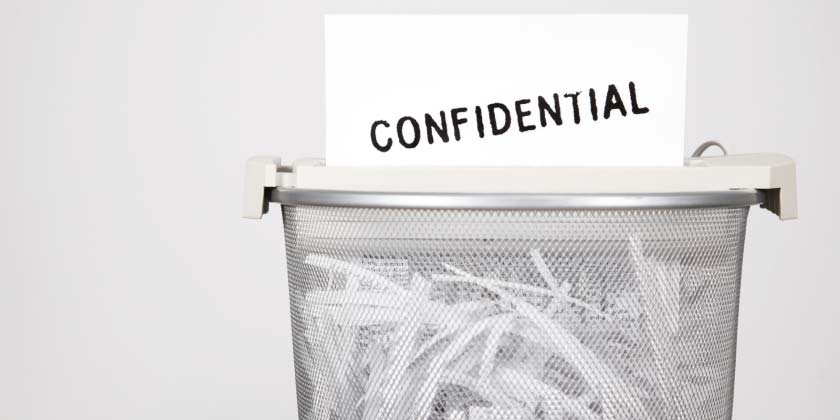 A shredder shredding a confidential letter