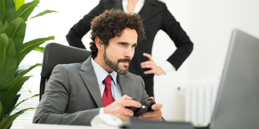 A business man playing video games at work