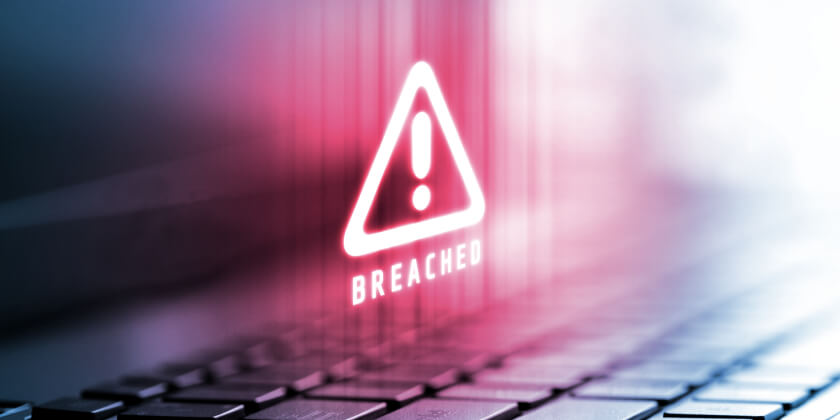 A Breached warning icon on a laptop