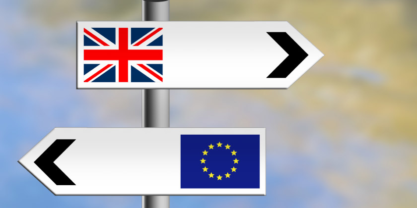 Road signs with EU & UK Flags pointing in different directions