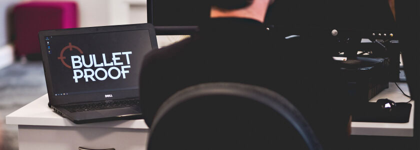 Laptop displaying the Bulletproof logo on a desk