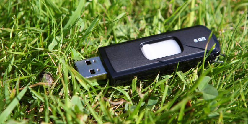 A USB key laying on grass